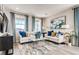 Comfortable living room with stylish decor and plenty of natural light at 2078 Wagon Wheel Aly, Brighton, CO 80601