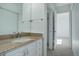 Bright bathroom featuring a granite vanity top, white cabinets, and modern fixtures at 2497 S Victor St # F, Aurora, CO 80014