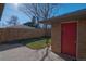 Cozy backyard with a grassy area, patio, and a brick storage shed at 3671 Hudson St, Denver, CO 80207