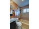 Tiled bathroom featuring a shower-tub combo, toilet, and updated vanity sink at 3671 Hudson St, Denver, CO 80207