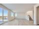 Bright open living area with staircase, large windows, and hard surface floors at 14139 Bunny Hop Ln, Parker, CO 80134