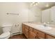 Bathroom featuring a vanity, sink, and toilet at 7915 Flower St # D, Arvada, CO 80005