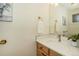 Bright bathroom with a wooden vanity, modern faucet, and elegant decor at 7915 Flower St # D, Arvada, CO 80005