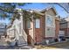 Charming home featuring brick and siding, plus a welcoming staircase to the entrance at 7915 Flower St # D, Arvada, CO 80005