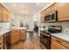 Modern kitchen featuring white subway tile, stainless steel appliances, and wood cabinets at 7915 Flower St # D, Arvada, CO 80005