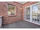 Private brick patio with window and doors leading into the home at 7915 Flower St # D, Arvada, CO 80005