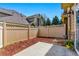 A fenced-in backyard with a concrete patio and low-maintenance mulch landscaping, offers a private outdoor retreat at 9980 W Jewell Ave # B, Lakewood, CO 80232