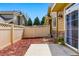 Fenced backyard with patio, great for outdoor activities and privacy, complemented by tidy mulch beds at 9980 W Jewell Ave # B, Lakewood, CO 80232
