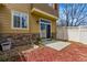 Private patio area with sliding glass doors, red mulch, and white lattice fencing, perfect for outdoor relaxation at 9980 W Jewell Ave # B, Lakewood, CO 80232