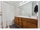 Bathroom with tub, shower, and wood vanity at 9980 W Jewell Ave # B, Lakewood, CO 80232