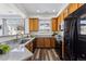 Spacious kitchen boasts granite countertops, stainless steel appliances, and wood cabinets at 9980 W Jewell Ave # B, Lakewood, CO 80232