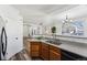Eat-in kitchen with granite countertops, stainless steel appliances, and wood cabinets at 9980 W Jewell Ave # B, Lakewood, CO 80232