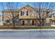 Inviting townhomes with stone accents, red doors, bare trees, and well-maintained landscaping create a charming curb appeal at 9980 W Jewell Ave # B, Lakewood, CO 80232
