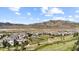 Community aerial view featuring plentiful homes, green space, a playground, and mountain views at 15290 W Baker Ave, Lakewood, CO 80228