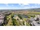Scenic aerial view of a developing community with lakes, walking paths, and mountain views at 15290 W Baker Ave, Lakewood, CO 80228