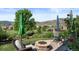 Charming backyard with a stone firepit, outdoor seating, lush lawn and mountain views at 15290 W Baker Ave, Lakewood, CO 80228