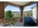 Covered balcony with stone and wood features has mountain views and a Weber grill at 15290 W Baker Ave, Lakewood, CO 80228