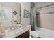 Bathroom featuring a granite vanity, decorative tiling, a white door and vanity mirror at 15290 W Baker Ave, Lakewood, CO 80228
