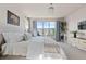 Well-lit bedroom featuring a large window with mountain views, ceiling fan, and plants at 15290 W Baker Ave, Lakewood, CO 80228