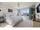 Bedroom featuring a large window with neighborhood views, a ceiling fan, and plants at 15290 W Baker Ave, Lakewood, CO 80228