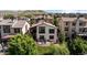 Back of beautiful two-story home with landscaped backyard and stone firepit seating area at 15290 W Baker Ave, Lakewood, CO 80228