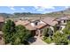 Beautiful home exterior with a tile roof, stone accents, and a well-manicured front yard at 15290 W Baker Ave, Lakewood, CO 80228
