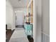 Bright hallway featuring a decorative mirror, lamps, dark wood flooring and white trim at 15290 W Baker Ave, Lakewood, CO 80228