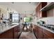 Open-concept kitchen and dining area with granite countertops and modern appliances at 15290 W Baker Ave, Lakewood, CO 80228