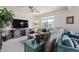 Cozy living room with TV, a large sectional sofa and a small blue painted side table at 15290 W Baker Ave, Lakewood, CO 80228