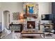Cozy living room featuring a stone fireplace and stylish decor at 15290 W Baker Ave, Lakewood, CO 80228