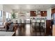 Open-concept living space with dining area and modern kitchen at 15290 W Baker Ave, Lakewood, CO 80228