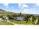 Aerial view of a community pool, clubhouse, and grassy green space at 15290 W Baker Ave, Lakewood, CO 80228