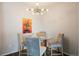 Small dining area with glass table and modern chandelier at 15700 E Jamison Dr # 7-205, Englewood, CO 80112