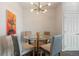 Small dining area with glass table and modern chandelier at 15700 E Jamison Dr # 7-205, Englewood, CO 80112