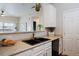 Kitchen features a double sink and white cabinets at 15700 E Jamison Dr # 7-205, Englewood, CO 80112