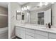 Bathroom with double sinks, a vanity, and a large mirror with modern lighting at 6041 S Salida Ct, Aurora, CO 80016