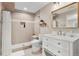 Updated bathroom featuring a step-in shower with tile surround, vanity with solid surface top, and white cabinetry at 6041 S Salida Ct, Aurora, CO 80016