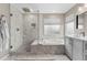 Bathroom featuring a sleek shower and soaking tub design with modern fixtures at 6041 S Salida Ct, Aurora, CO 80016