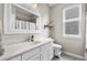 Bathroom with white vanity, ample lighting, and a bathtub shower at 6041 S Salida Ct, Aurora, CO 80016