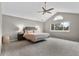 Vaulted ceiling main bedroom with ceiling fan and large window providing natural light at 6041 S Salida Ct, Aurora, CO 80016