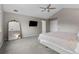 Bright bedroom featuring a television, stylish mirror and neutral décor at 6041 S Salida Ct, Aurora, CO 80016
