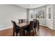 Dining room featuring hardwood floors, large windows, and a six-chair dining set at 6041 S Salida Ct, Aurora, CO 80016