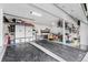 Well-organized garage with cabinets, overhead storage, and epoxy floor coating at 6041 S Salida Ct, Aurora, CO 80016