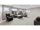 Living room with a gray sectional sofa, chair, and windows with outside views at 6041 S Salida Ct, Aurora, CO 80016