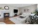 Bright living room features a fireplace, hardwood floors, and a comfortable seating area at 6041 S Salida Ct, Aurora, CO 80016