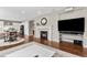 Open living room with a fireplace, hardwood floors, and an adjacent dining area at 6041 S Salida Ct, Aurora, CO 80016