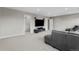 Spacious living room with built-in shelves, a large TV, and comfortable seating at 6041 S Salida Ct, Aurora, CO 80016