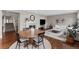 Cozy living area with a fireplace, hardwood floors, and an adjacent dining area at 6041 S Salida Ct, Aurora, CO 80016