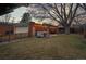 Large backyard with a garage, covered porch, and string lights, perfect for outdoor gatherings and enjoying the evening at 1545 Locust St, Denver, CO 80220