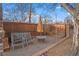 Cozy backyard offers comfortable seating, gravel area, and a wooden privacy fence, a nice place to relax at 1545 Locust St, Denver, CO 80220